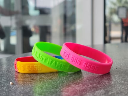 Embossed silicone wristbands for child safety while traveling