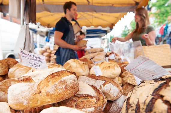 Photo of family members at a family reunion sharing gifts and shopping at a bake sale