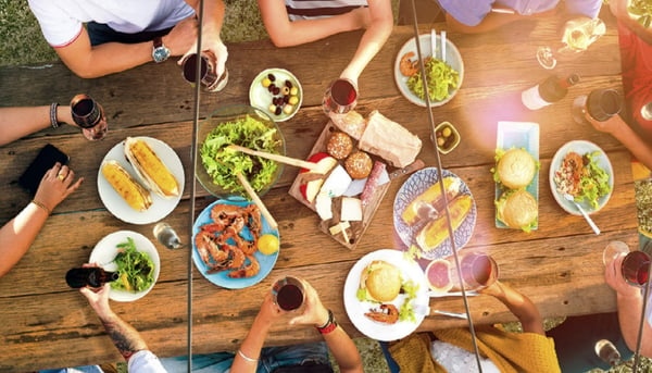 Photo of families at a table with water and food