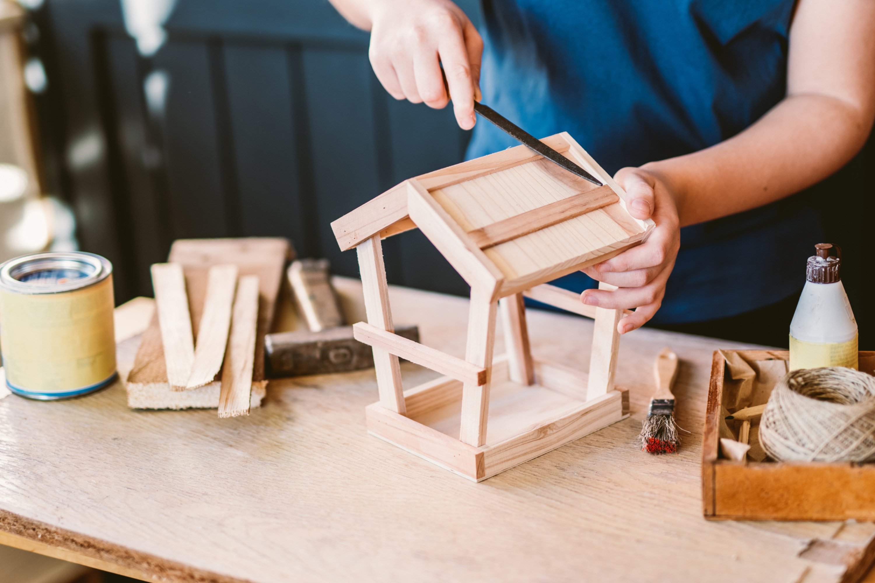 A camper making a bird feeder at summer camp