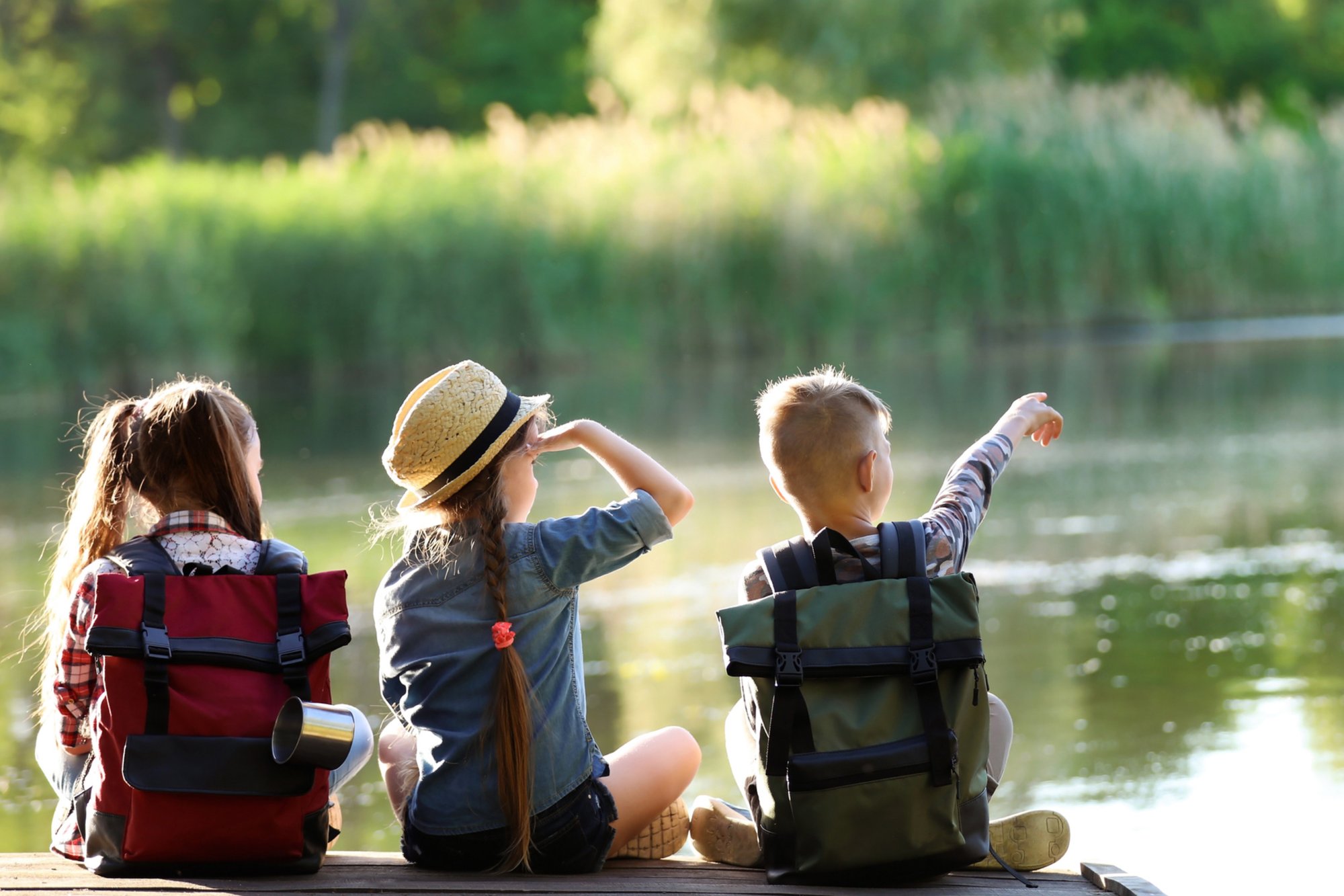 Neighborhood kids at a kids summer camp looking out over a lake