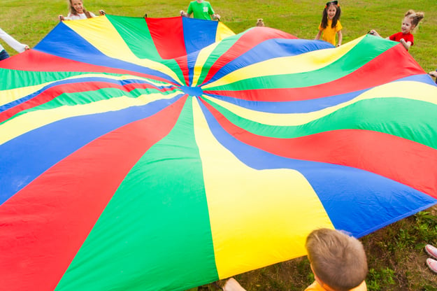 Campers playing a parachute game