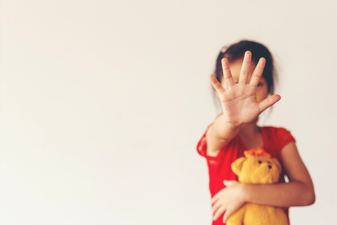 a young girl holding her teddy bear. Here are several ways to spread child abuse prevention awareness.