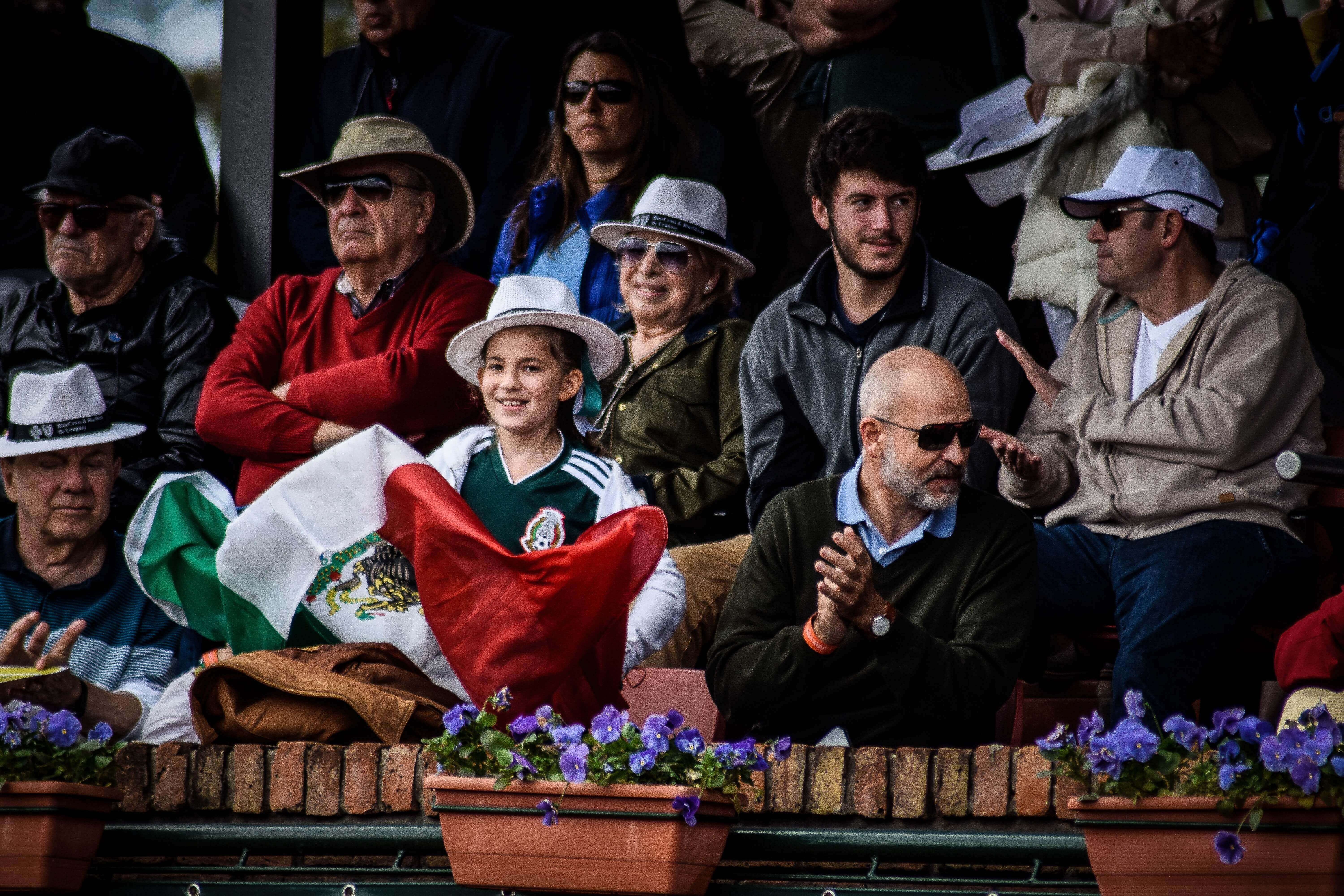 People celebrating Cinco de Mayo with the Mexican flag.