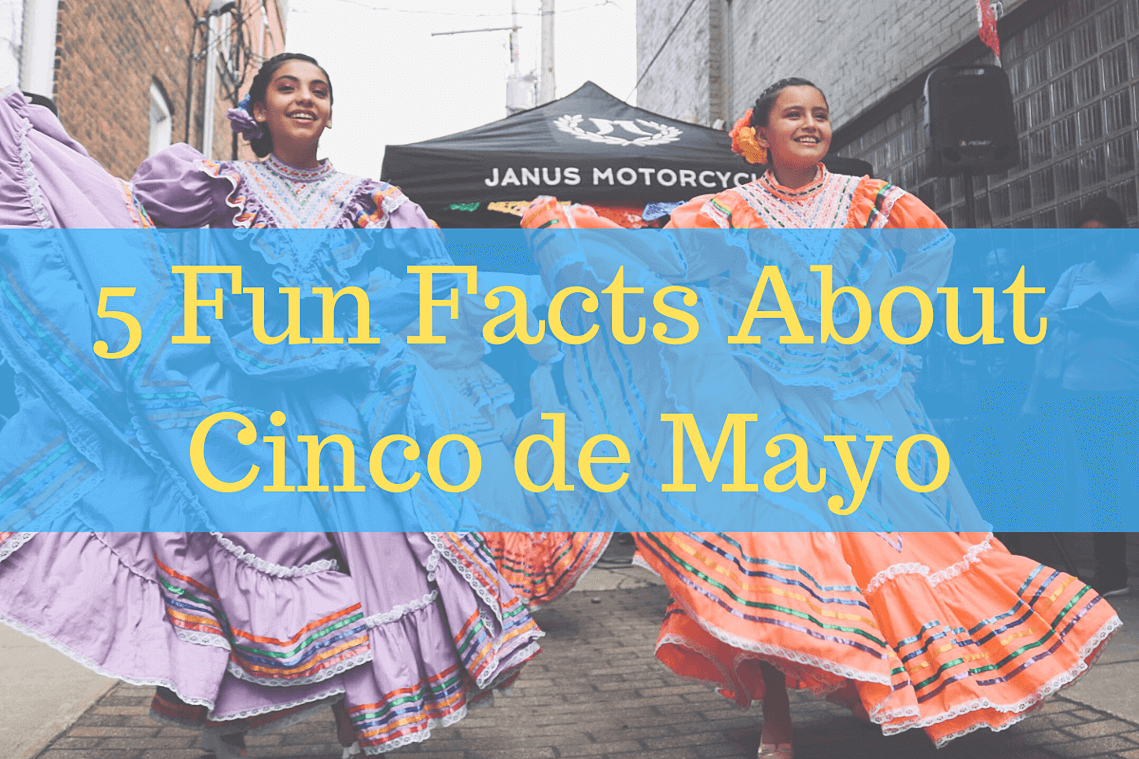 Girls dancing in bright dresses in the street celebrating Cinco de Mayo.