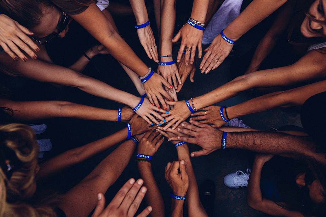 individuals wearing blue wristbands.