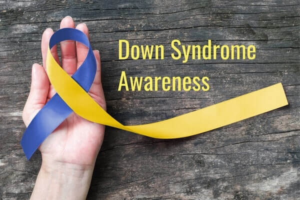Blue and yellow ribbon represents down syndrome awareness.