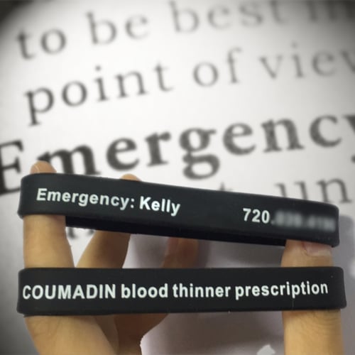 Black Rubber Bracelet That Says Emergency Contact Kelly with Phone Number in White Ink