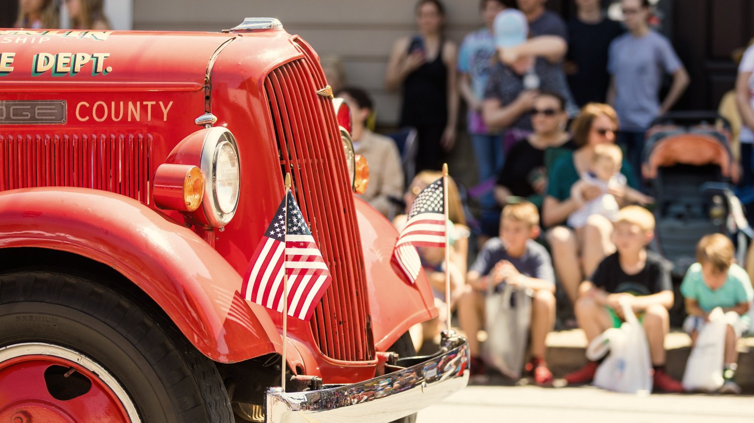 Photo of a vintage fire truck at a Memorial Day parade celebration