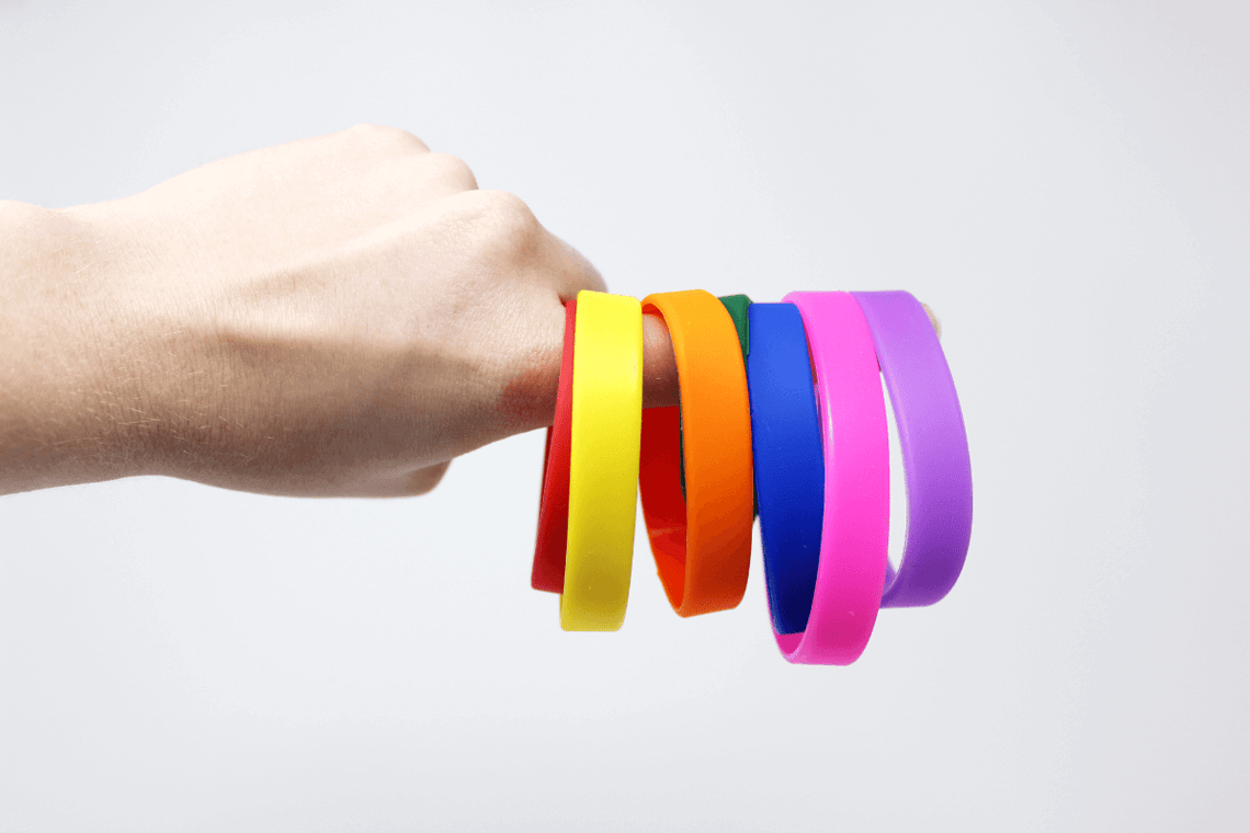 colorful wristbands representing pride month.