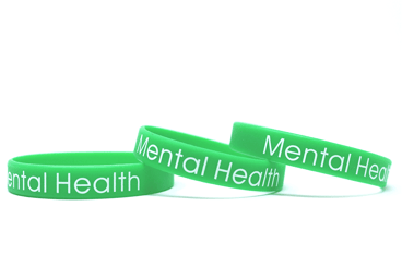 Green printed wristbands that says mental health awareness.