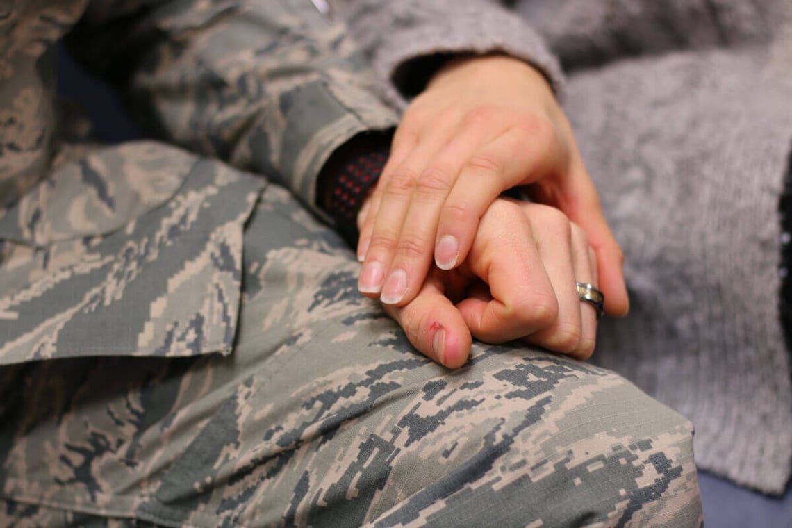 soldier holding a friends hand.