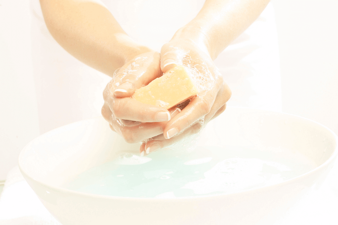 A person washing away the germ with soap. Wristbands are known to carry germs.