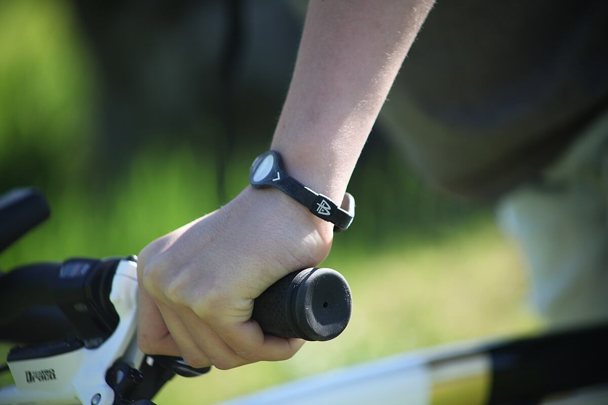 An individual wearing a black balance wristband.