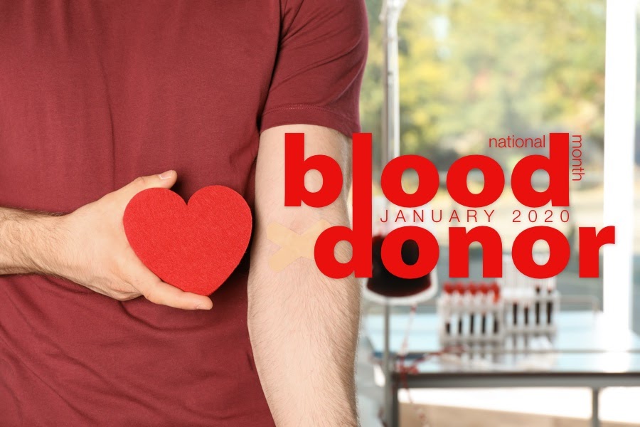 A man holds a red piece of paper cut into a heart-shape. There is stylized red text on the photo that reads "January 2020: National Blood Donor Month"