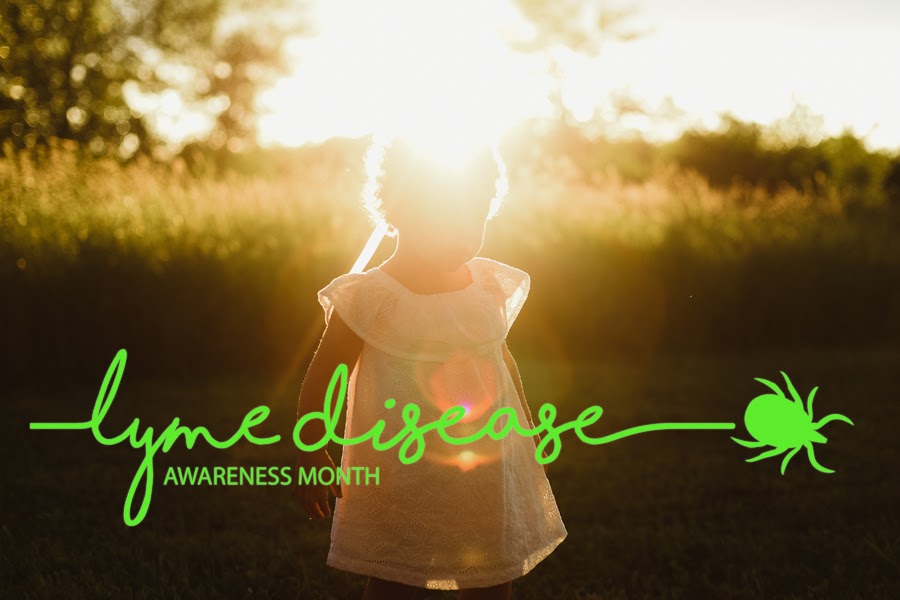 A little girl playing in a field near high grass. The words "Lyme disease awareness month" in green