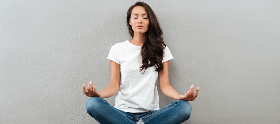 Beautiful woman meditating indoors